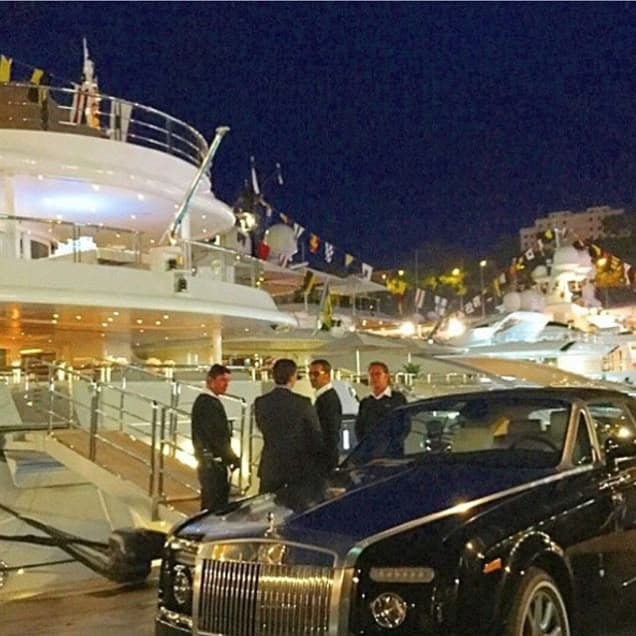 VIP arrival beside a yacht at night