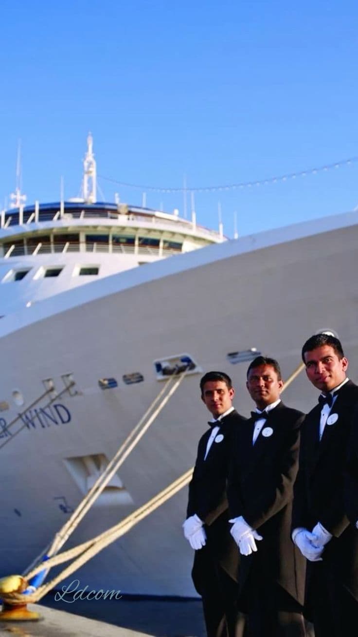 Formal yacht staff standing beside a luxury vessel