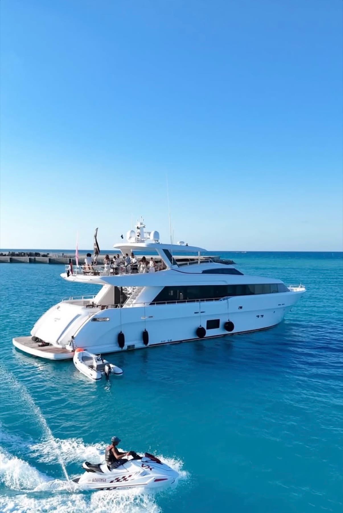 Private motor yacht and watercraft in the clear water of Marassi